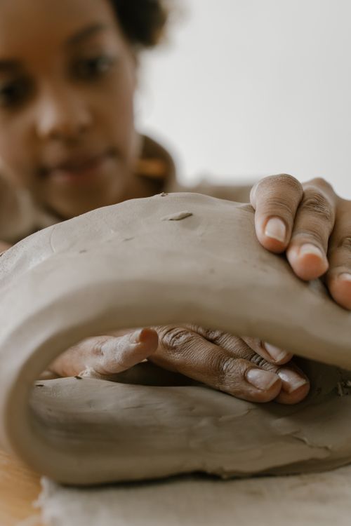 Free Detailed close-up of a woman's hands molding clay, showcasing intricate craftsmanship. Stock Photo
