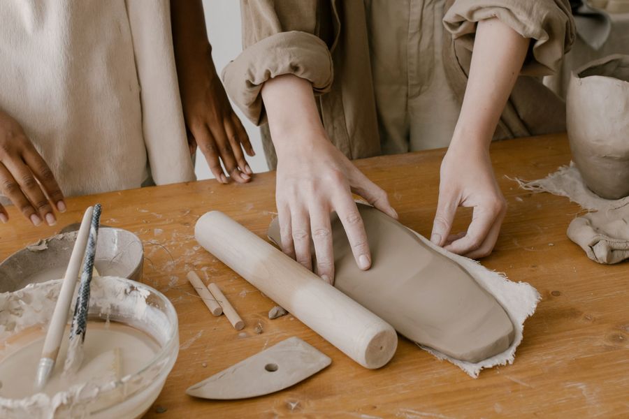 Hands rolling material on a work table