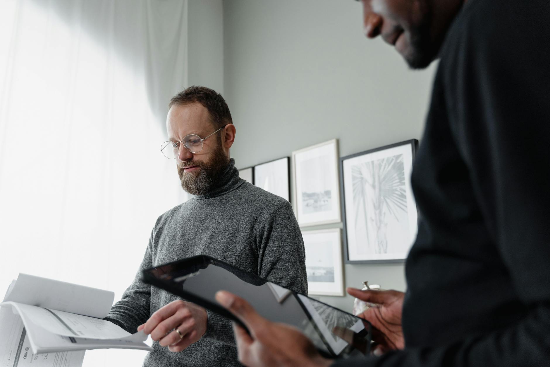 Man in Black Long Sleeve Shirt Holding Black Tablet Computer