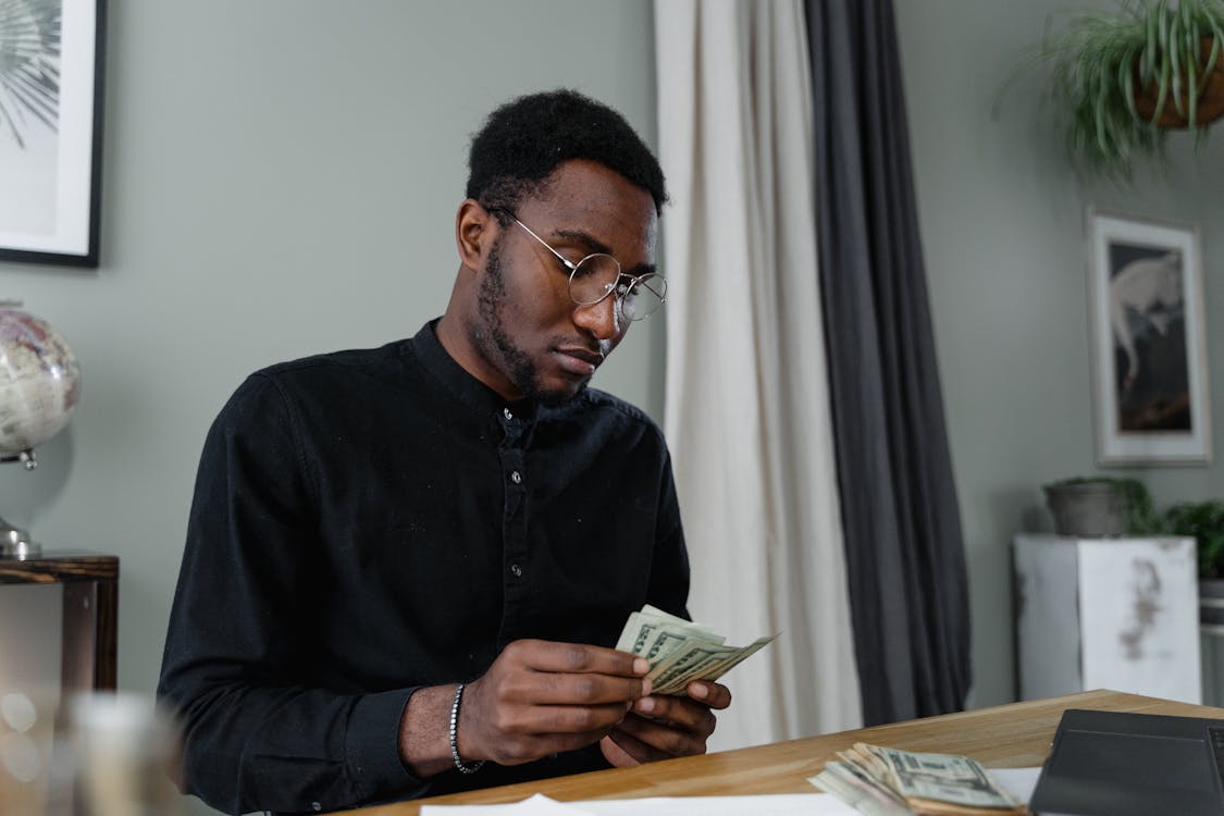 Free A Man Counting Money Stock Photo