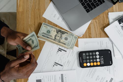 Free Accounting Cash Money Using a Calculator Stock Photo