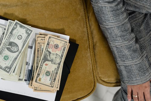 Free Cash Money over the Couch Cushion Stock Photo