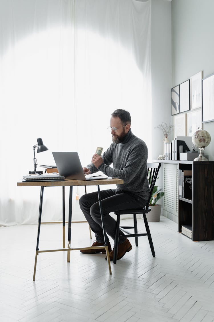 Man Sitting At His Desk