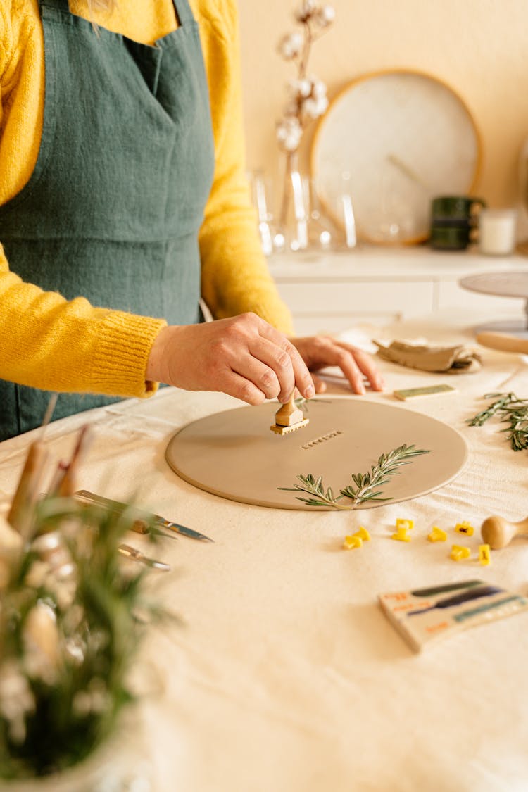 A Woman Stamping A Dough