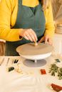A Person Stamping a Flatten Clay Dough