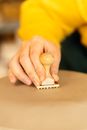 A Person Stamping a Brown Surface