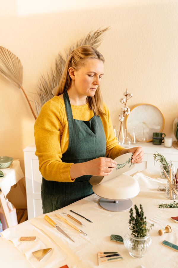 Elena examining a finished piece
