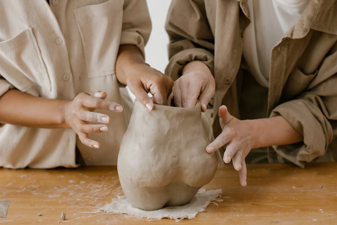 Free People Molding a Clay Stock Photo