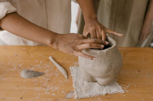 Person Making a Sculpture out of Clay 
