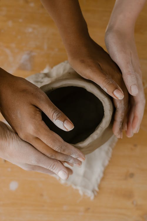 Hands Sculpting a Vase 