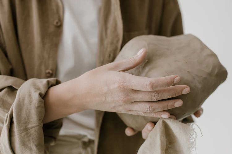 Hands Of A Person Sculpting Clay