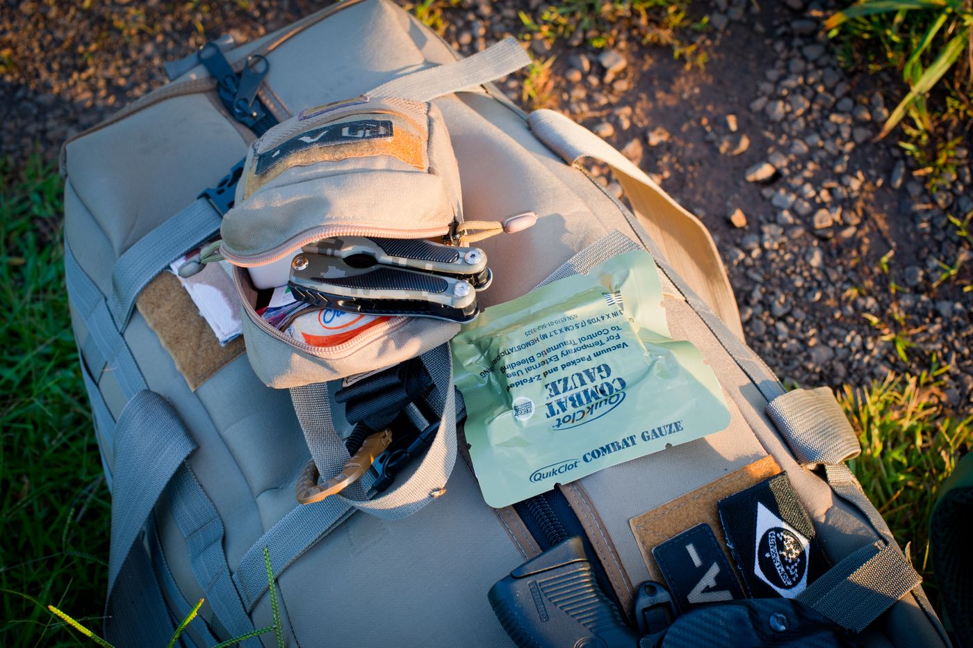 Outdoor backpack and essential equipment arranged for inspection