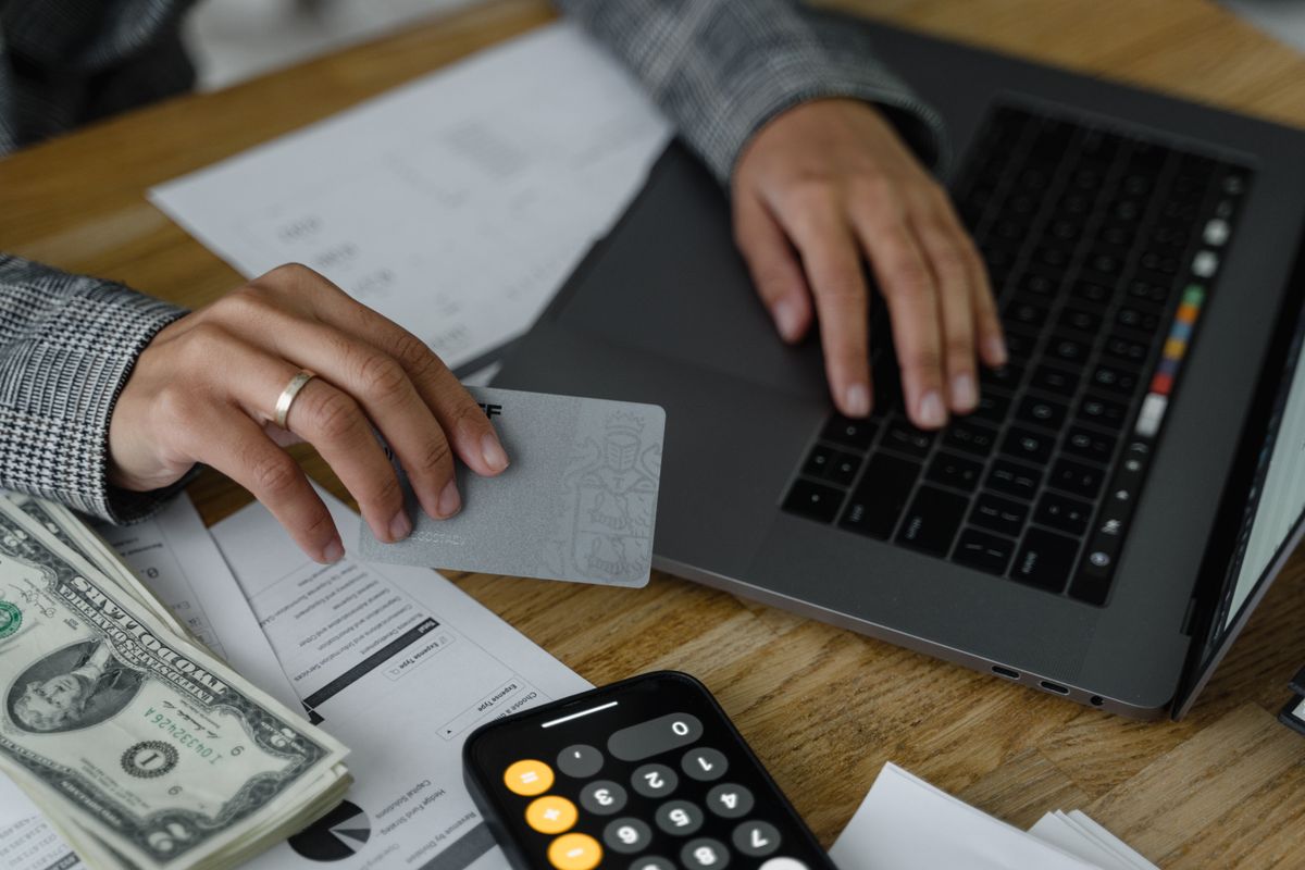 Reviewing bank statements and credit card accounts at a desk