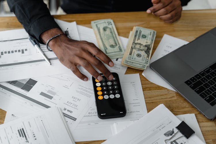 Hand Of A Person Using A Calculator