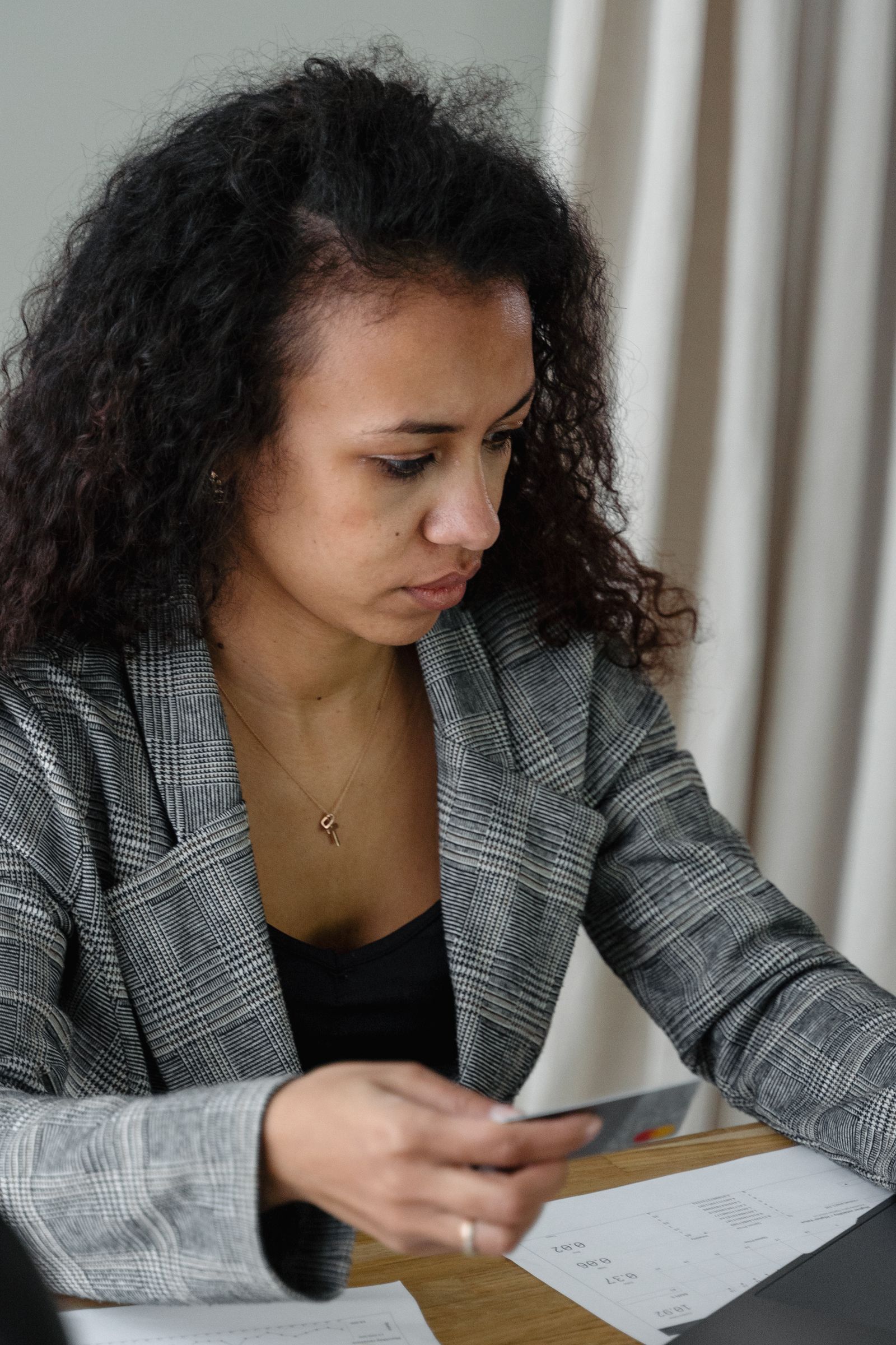 Professional reviewing financial paperwork at an office desk