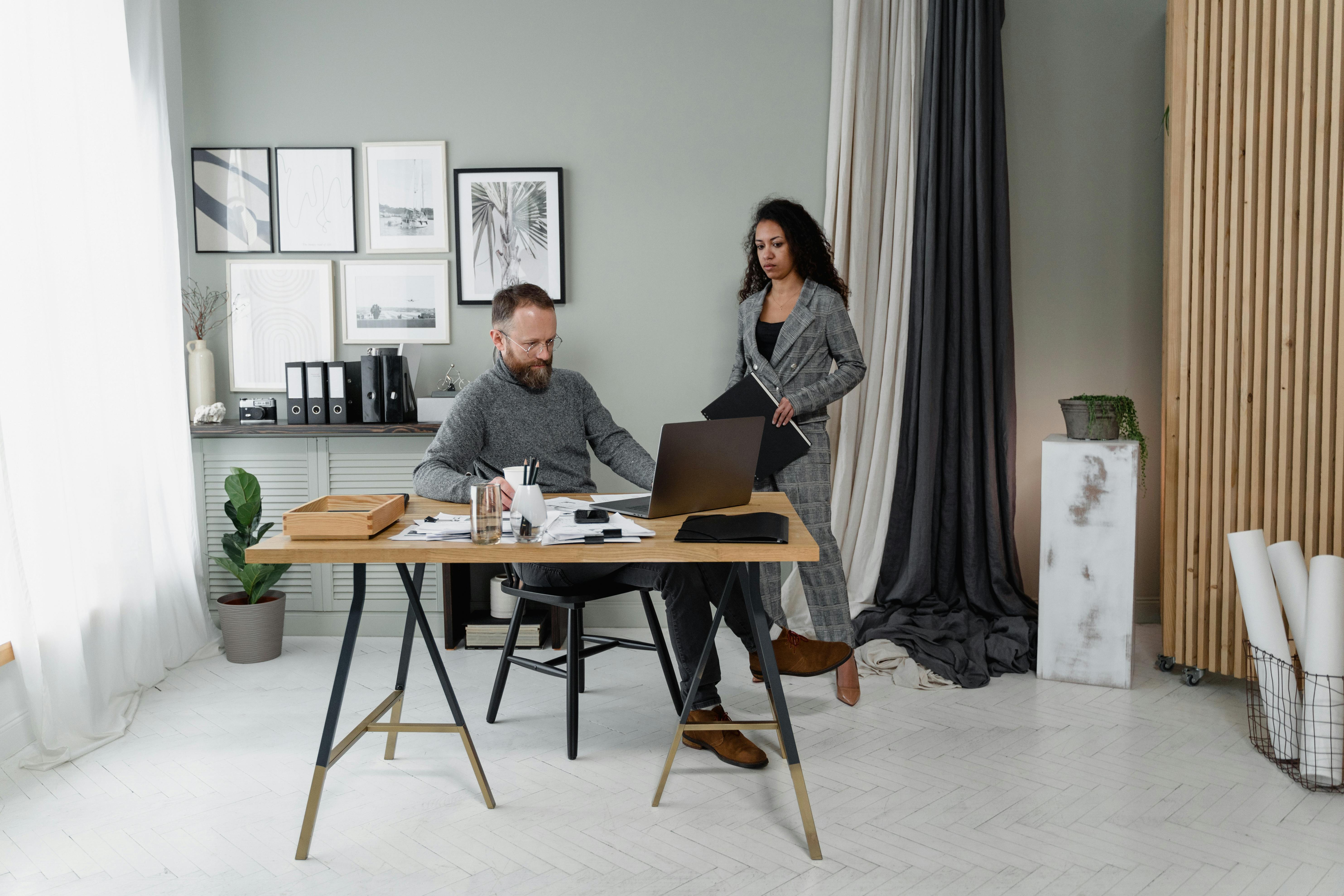 Adult working at a standing desk in a modern office with ergonomic design
