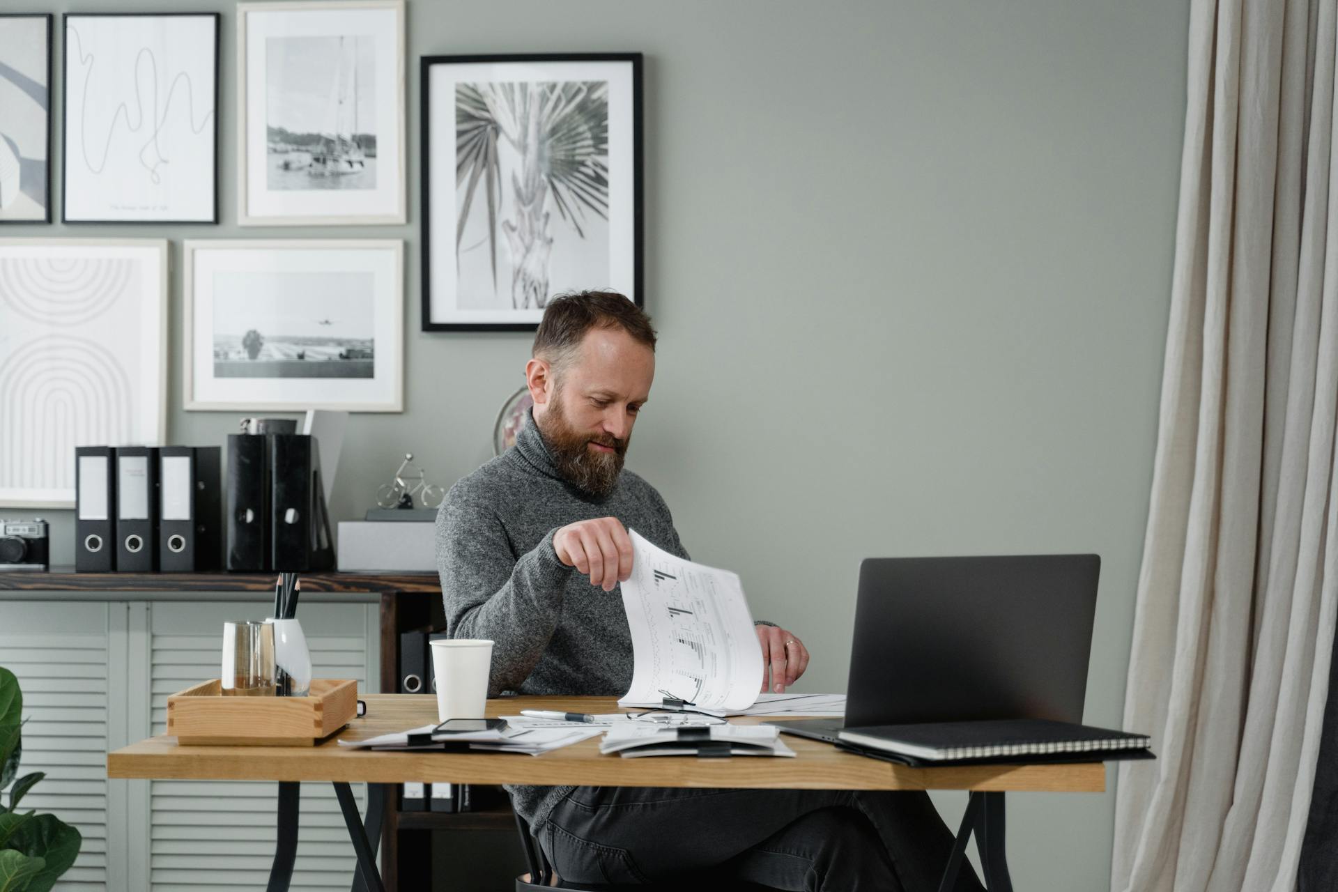 A Man Looking at Documents in the Office