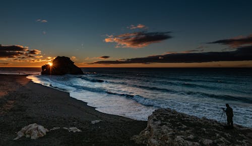 Ocean Waves Crashing on Shore During Sunrise