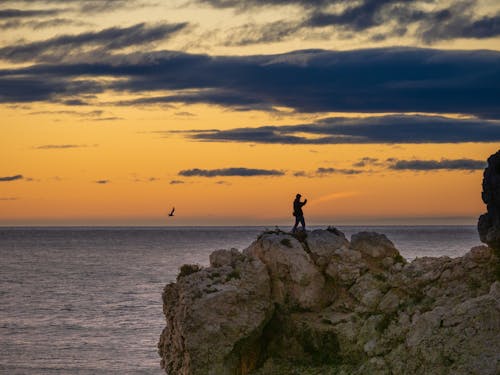 A Man Standing on the Rocks