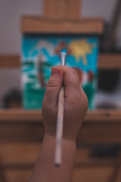 Hand Holding a Paintbrush 