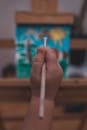 Hand Holding a Paintbrush