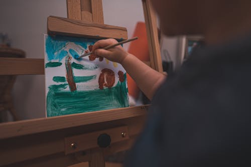 Free A Person Holding a Paint Brush Painting Stock Photo
