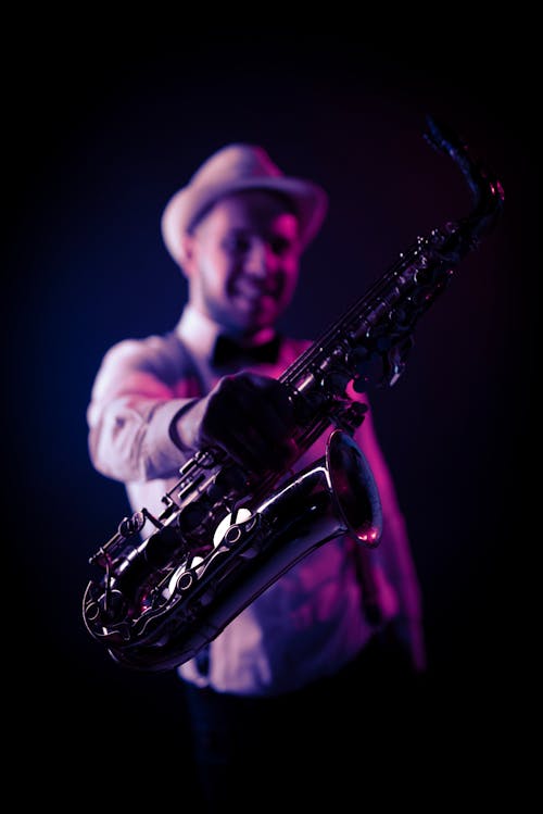 Free Man Holding a Saxophone Stock Photo