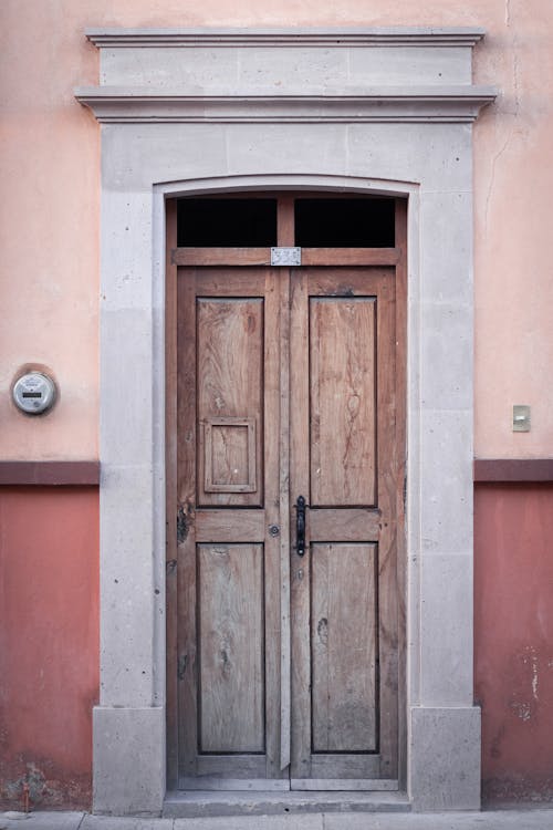 Brown Wooden Door on Concrete Wall