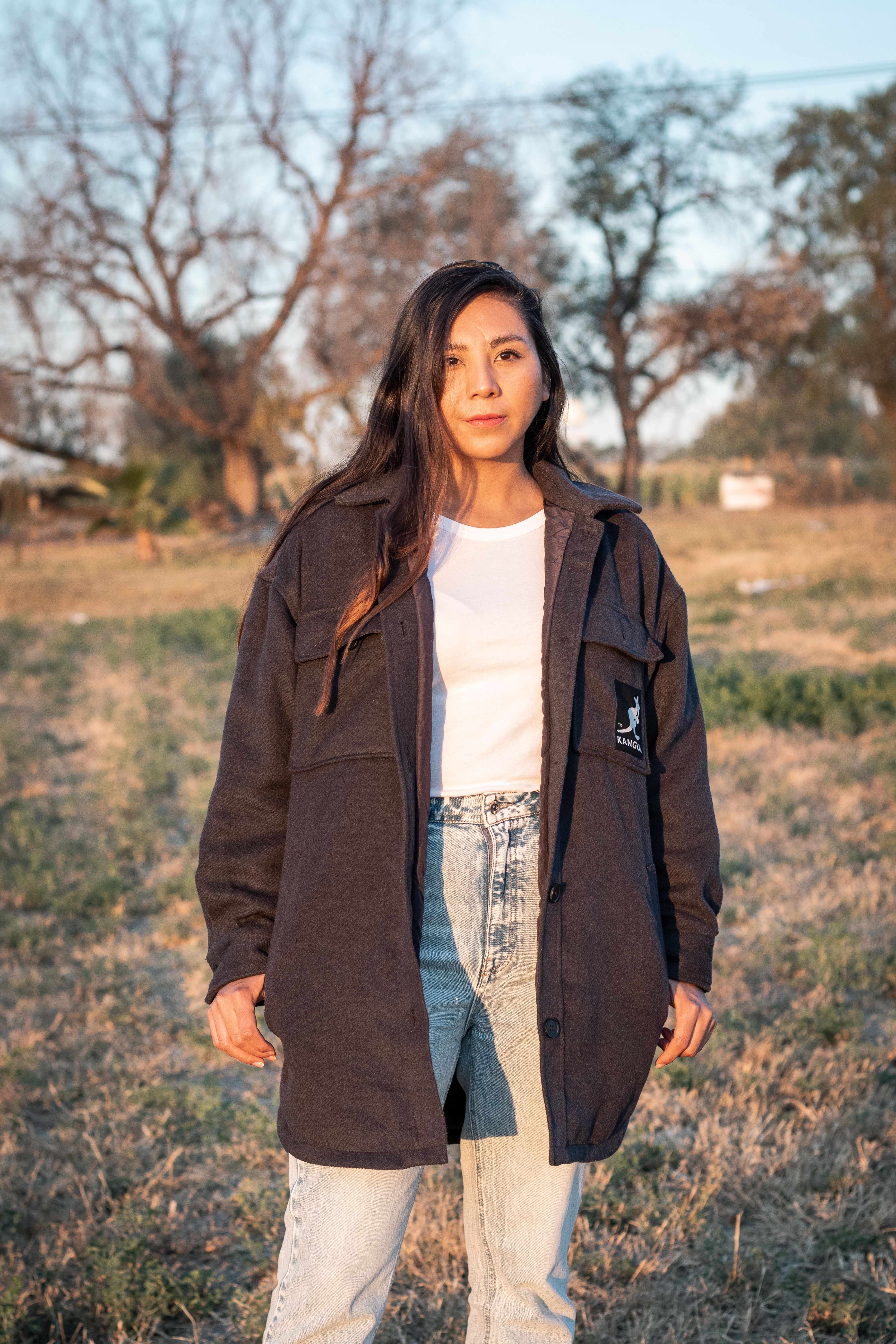 Woman in Black Jacket Standing on Grass · Free Stock Photo