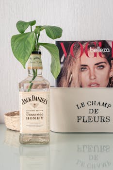 Creative display of Jack Daniel's bottle used as a plant vase on a chic table setup.