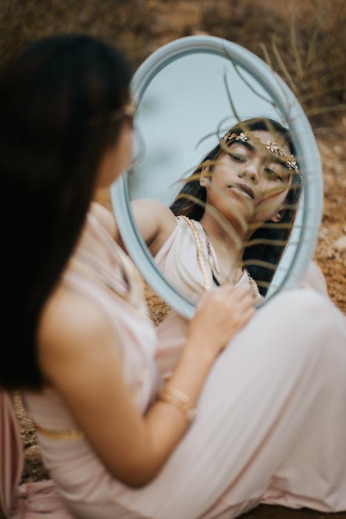 Free Woman in Dress Looking at the Mirror Stock Photo