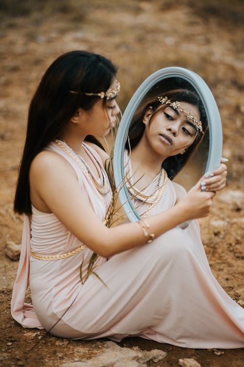 Woman in Dress Holding Round Mirror