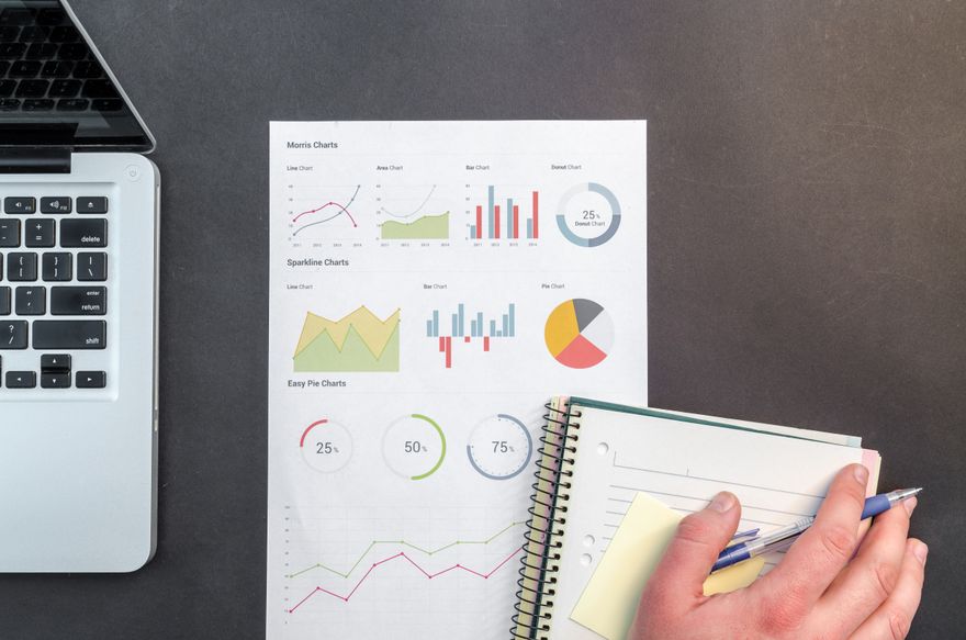 Printed analytics charts spread across a desk