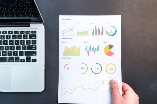 Person Holding Chart And Bar Graph How to Measure Your SEO Return on Investment