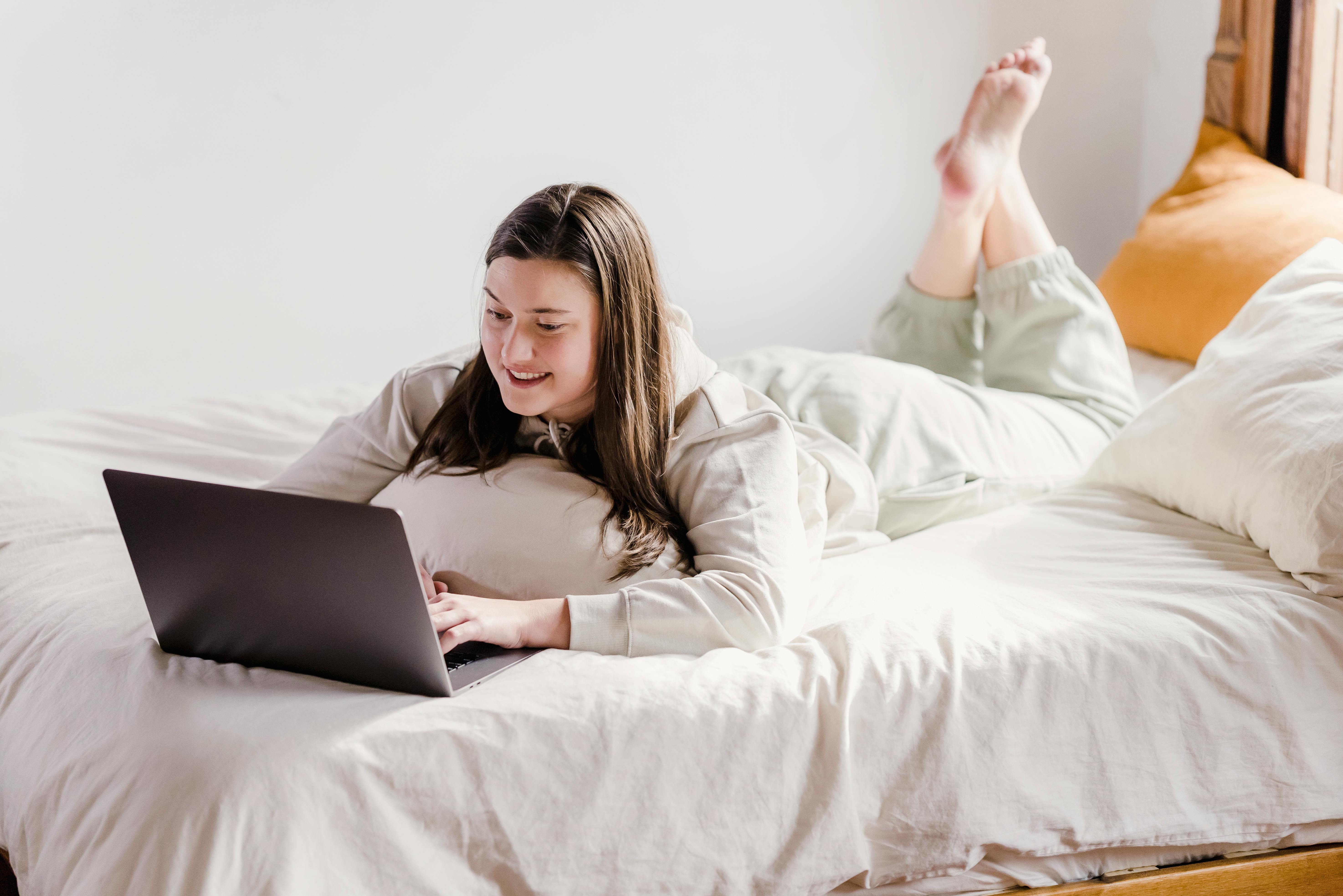 The Laptop And Computer In The Morning On A White Pillow Bed Lifestyle  Concept Stock Photo - Download Image Now - iStock
