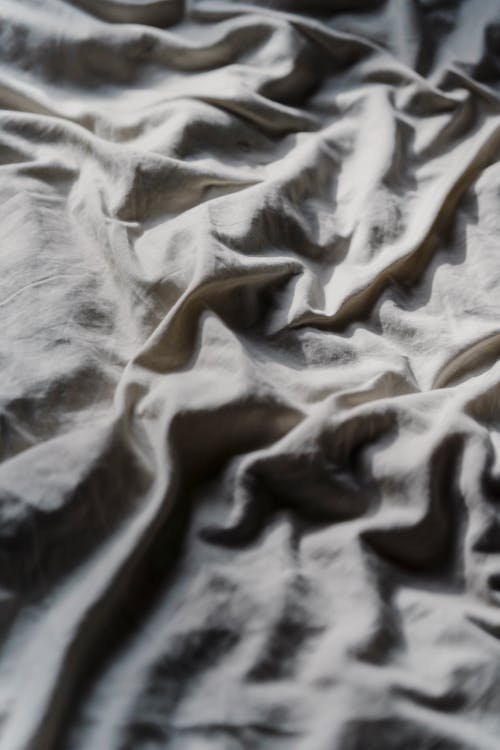 Crumpled fabric on soft bed
