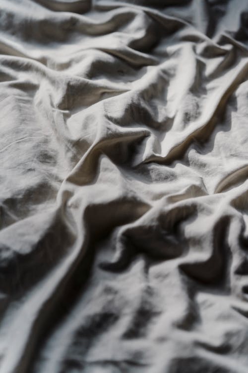 Crumpled fabric on soft bed
