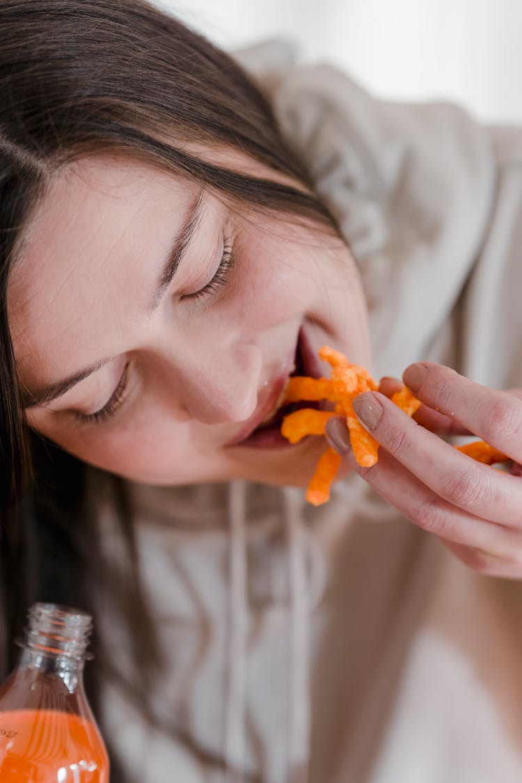 Young Woman Eating Corn Chips