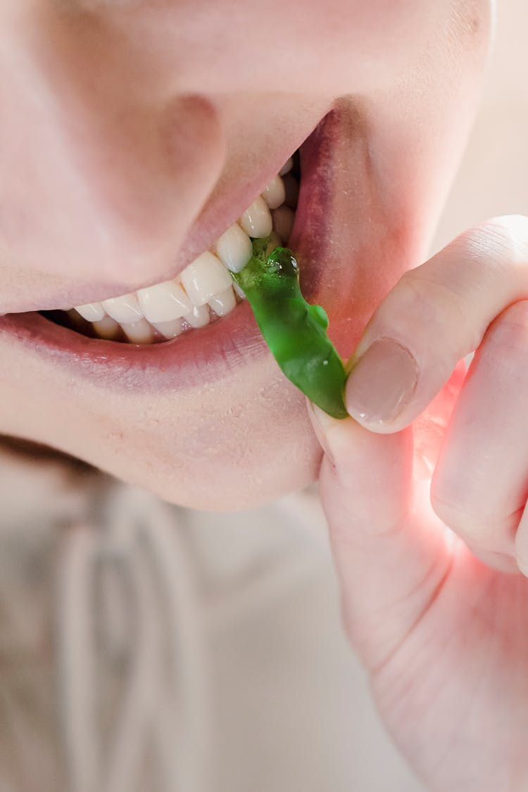 Cheerful Woman Biting Sweet Green Marmalade