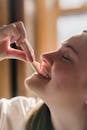 Glad young woman biting sweet marmalade