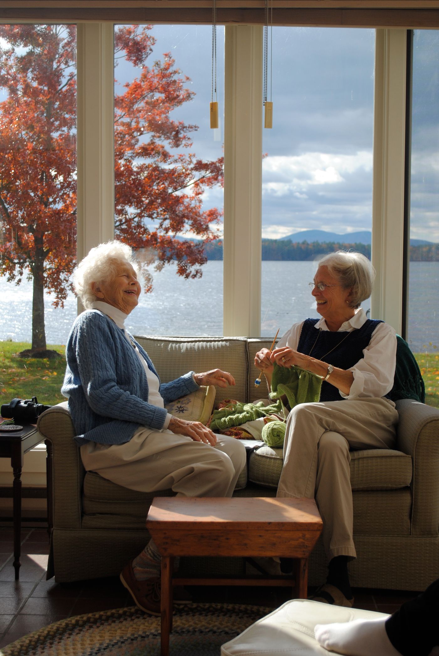 Illustrative photo of two older friends enjoying a warm conversation