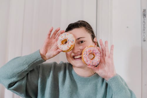 Cheerful woman with tasty doughnuts