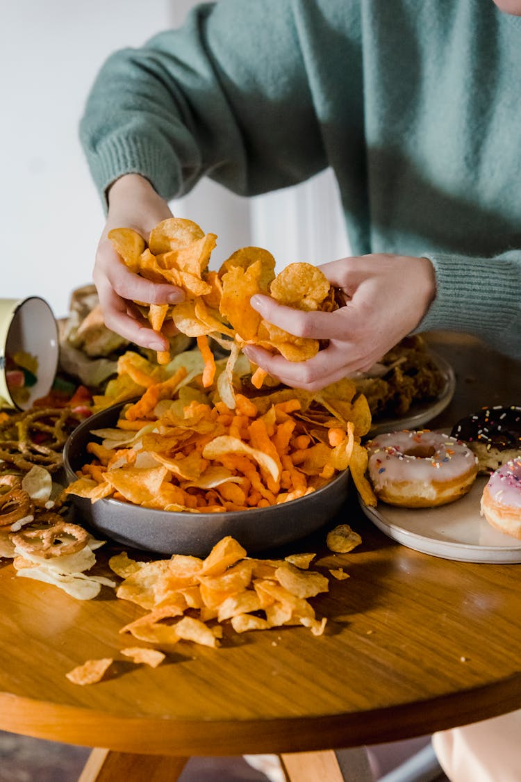 Crop Woman With Chips In Hands