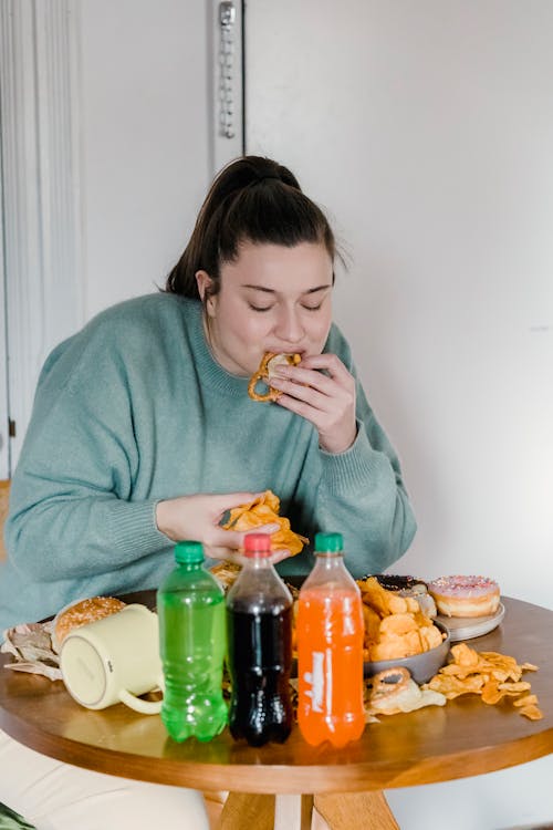 Free Hungry woman eating junk food Stock Photo