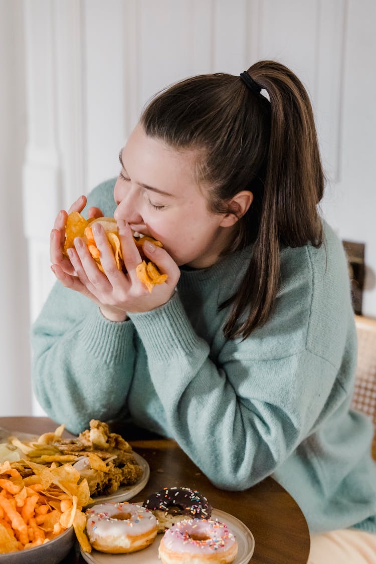 Woman Handful Of Unhealthy Chips