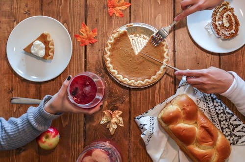 Free Slicing of Pumpkin Pie Placed on Wooden Surface Stock Photo