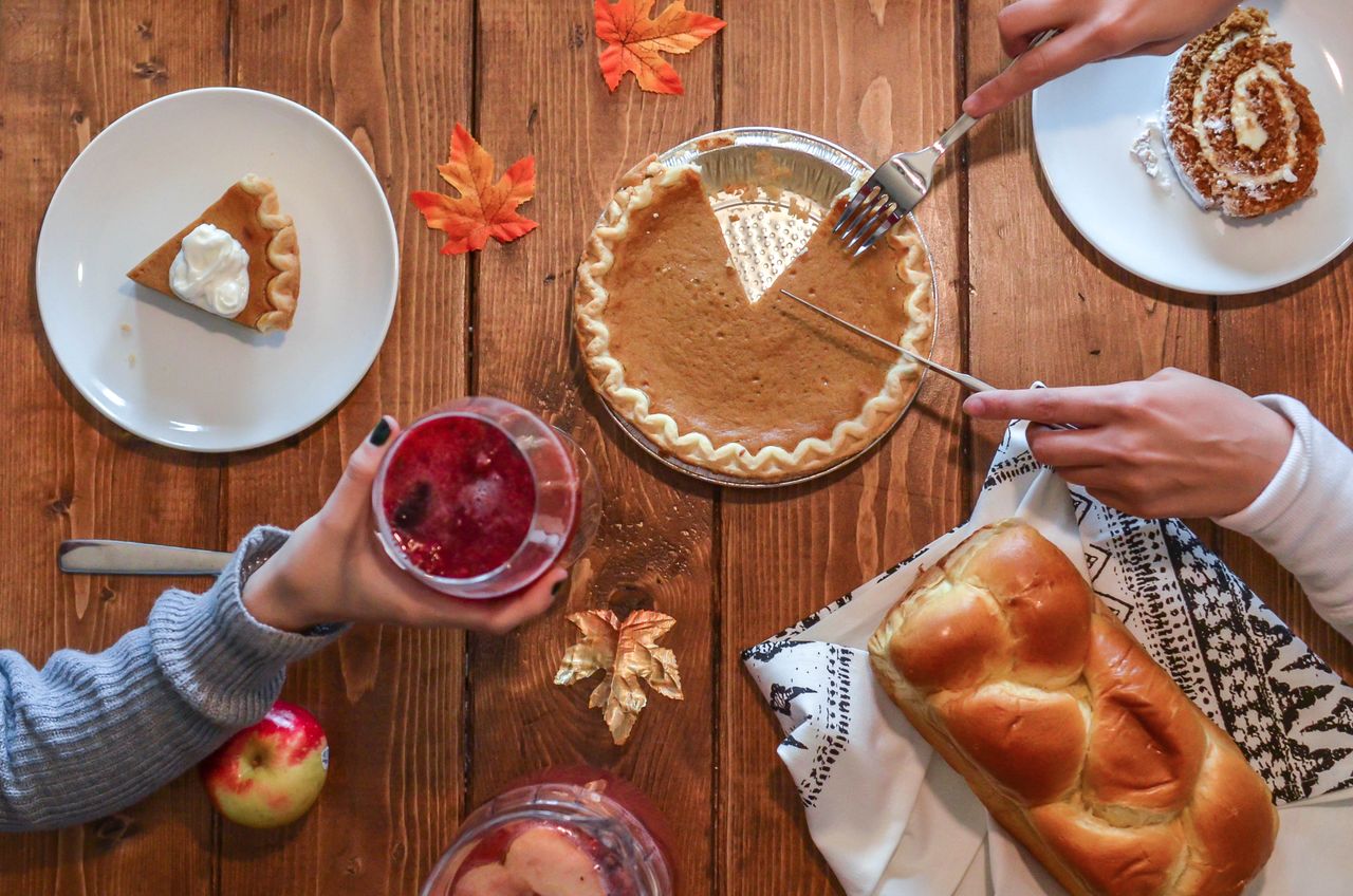 cozy autumn table setting with pumpkin pie bread and drinks perfect fo