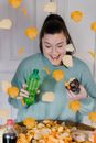 Happy woman with donut and bottle with beverage