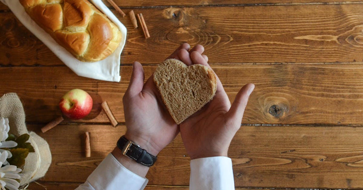 Person Holding Heart Shaped Bread