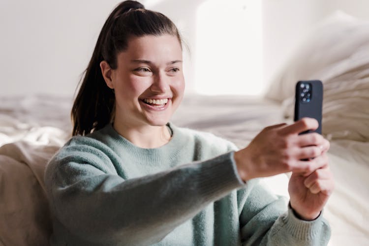 Smiling Young Woman Taking Selfie Photo